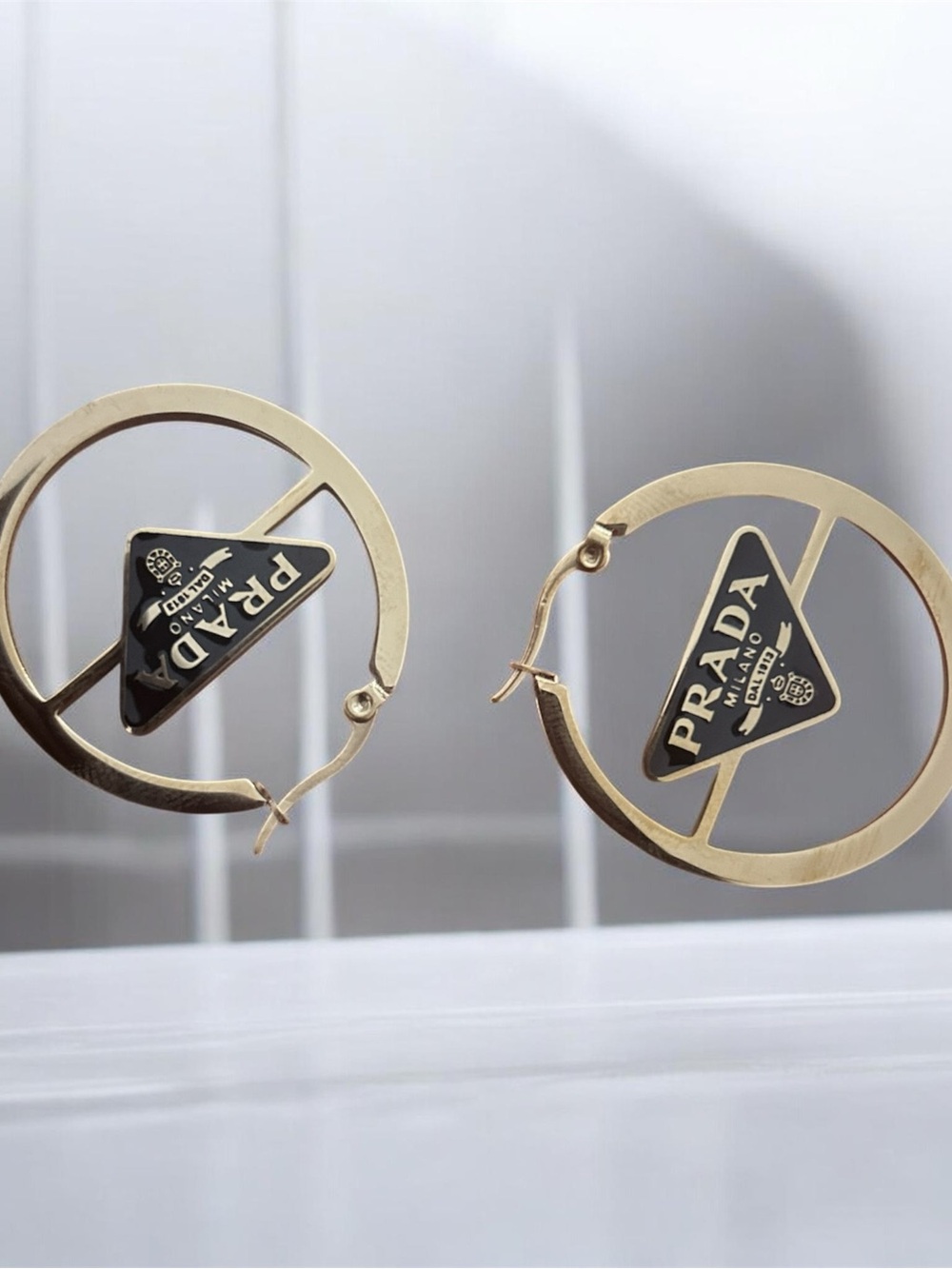 Prada Gold Hoop Earrings with Black Logo Triangle Charm